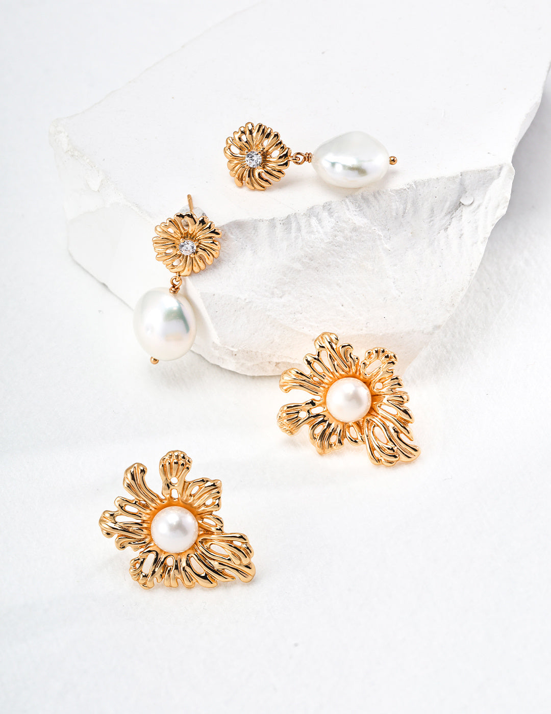 Beautiful golden earrings embellished with pearls and floral accents, offering a charming and stylish accessory for any occasion.