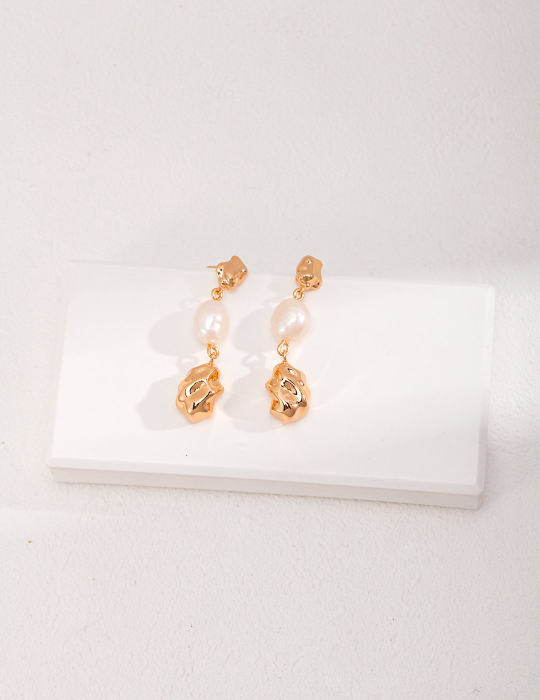 Classic gold dop earrings adorned with lustrous pearls, chic and sophisticated.