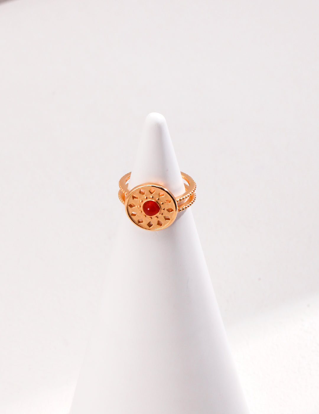 A stunning gold ring with a red agate stone, featuring a unique totem pattern.