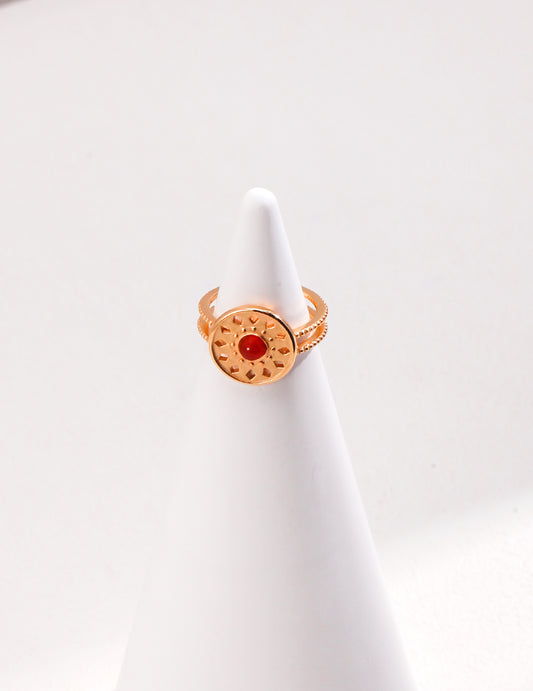 A stunning gold ring with a red agate stone, featuring a unique totem pattern.