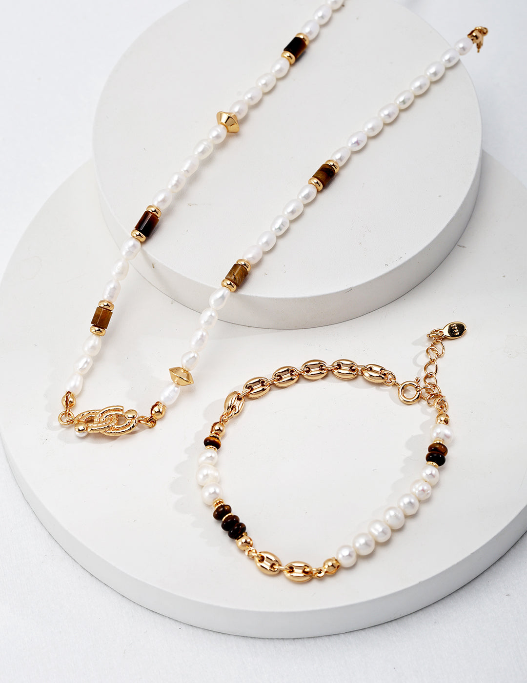 Luxurious gold necklace, bracelet, and earrings set for a glamorous look.