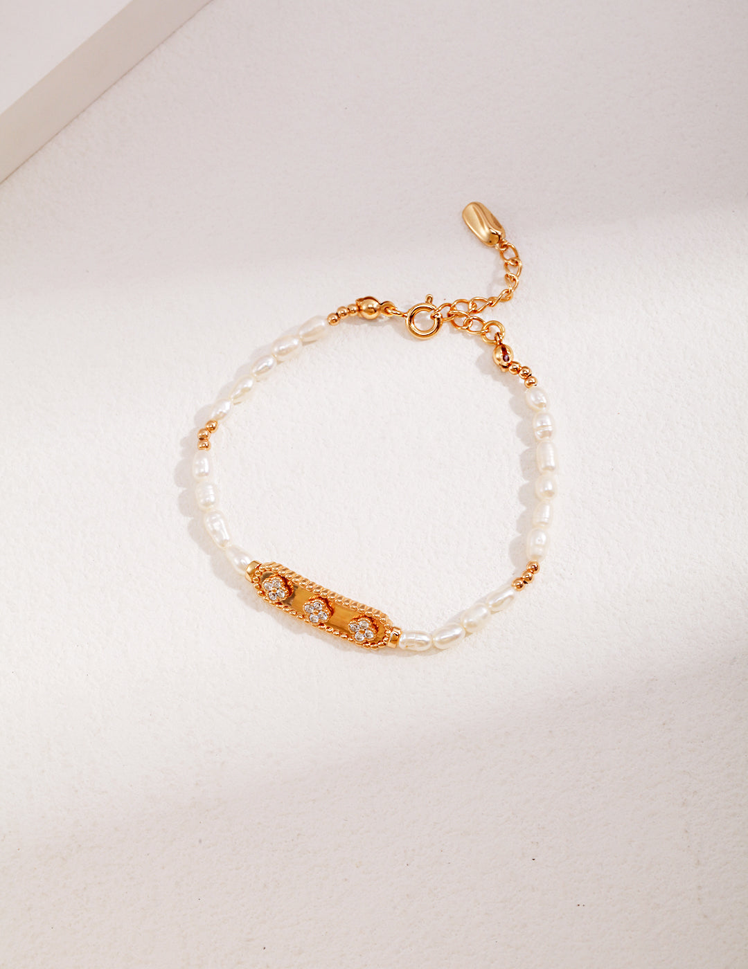 Luxurious gold bracelet featuring stunning pearls and sparkling cubic zirconia, a true statement piece.