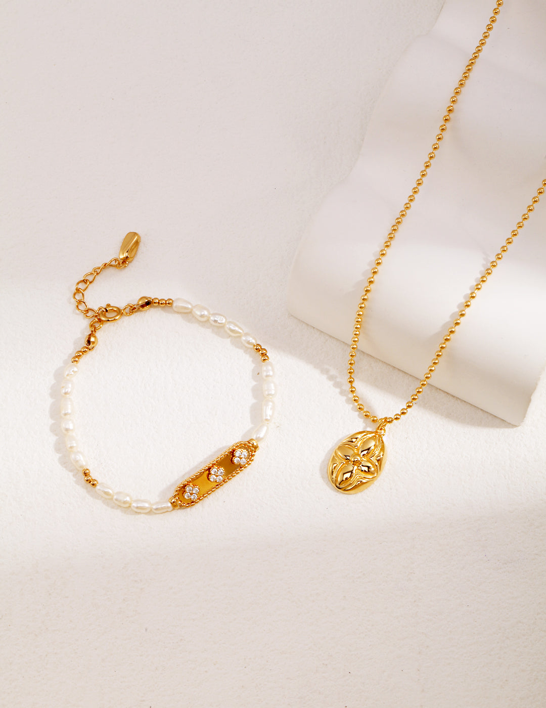 Elegant gold plated bracelet and a dainty gold chain necklace.