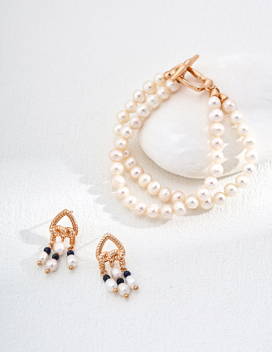 Stunning duo-layer freshwater pearl bracelets and earrings, exuding elegance and sophistication in a chic jewelry set.