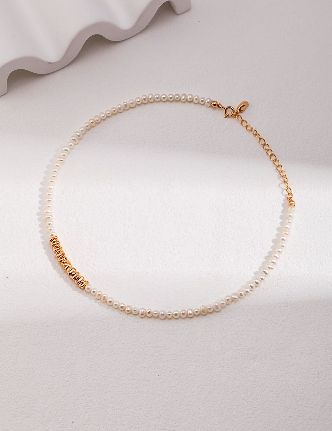 A luxurious gold chain necklace with gold plated beads and freshwater pearl beads.