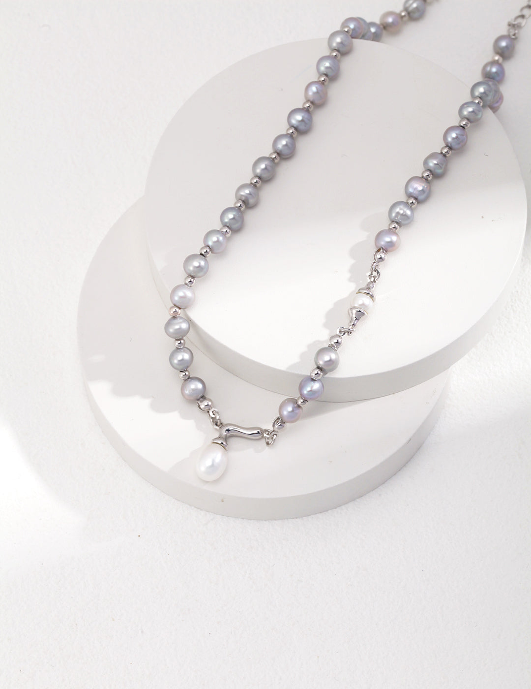 Stylish necklace adorned with a grey freshwater pearl on a silver chain.