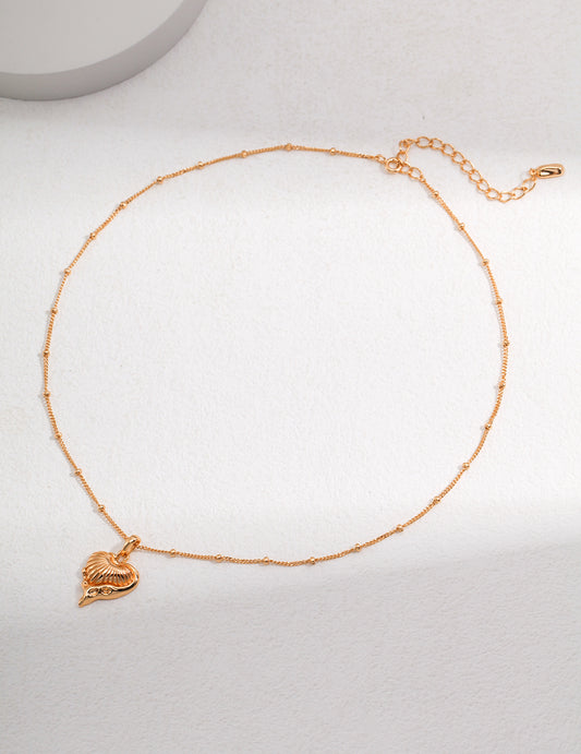 A beautiful gold chain necklace with a heart charm, perfect for adding a touch of elegance to any outfit.