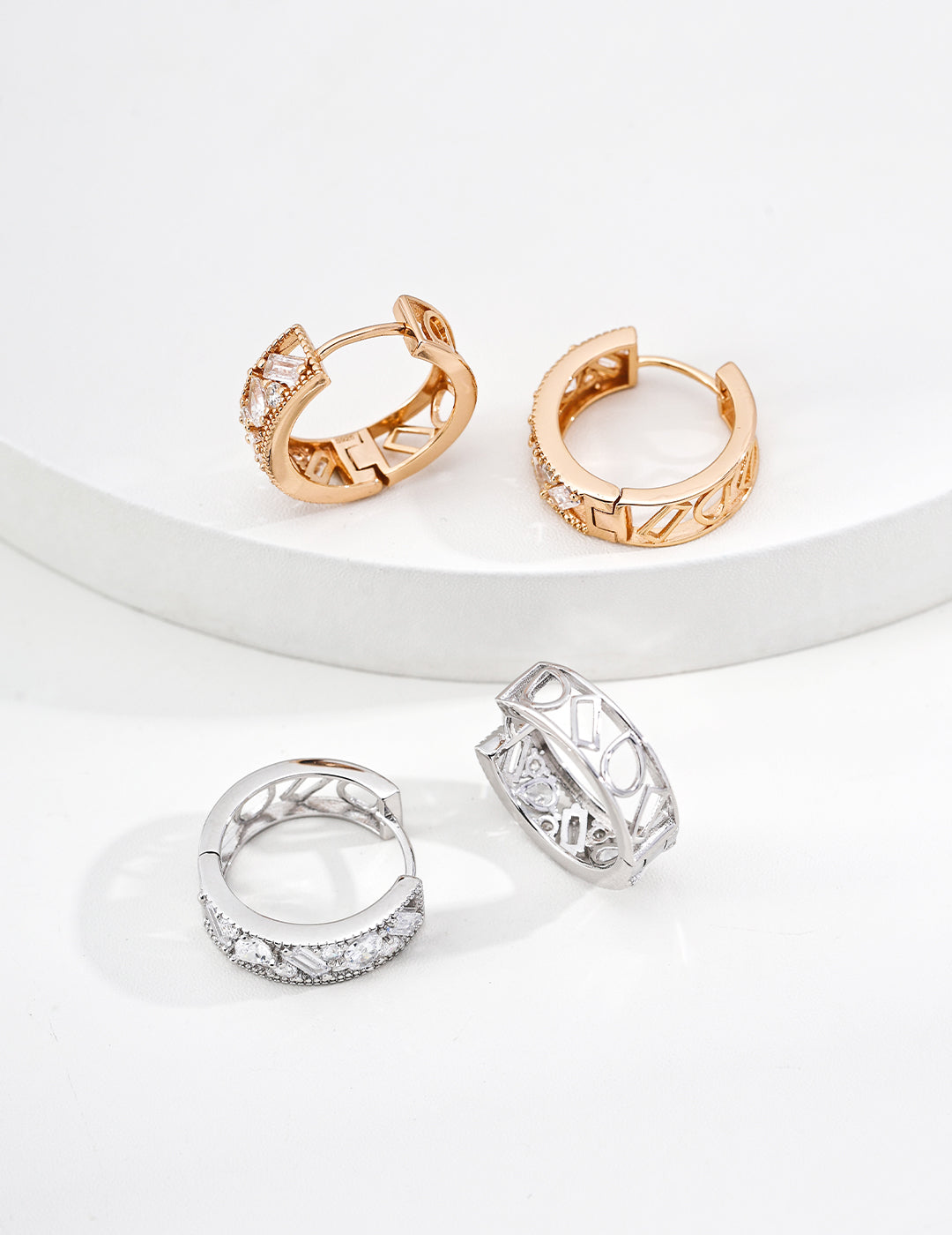Two sets of Edith Hoops ,minimal zirconia hoops in Gold and Silver by Mezuille, quiet luxury style.