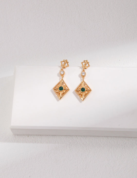 Beautiful gold earrings featuring exquisite zirconia stones, perfect for adding a touch of elegance to any outfit.