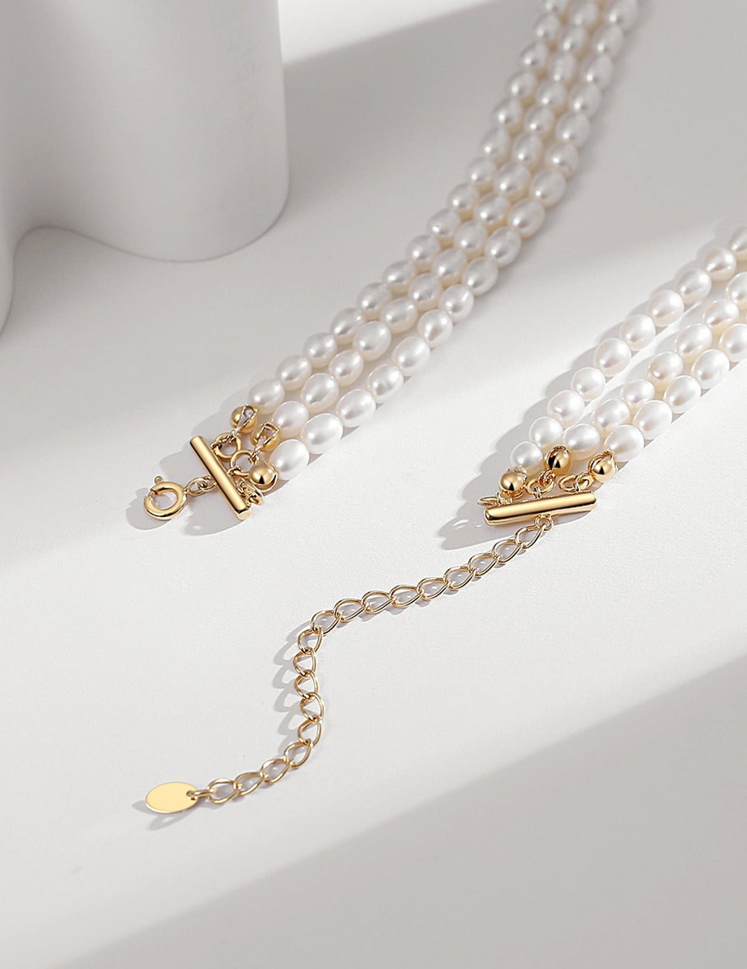 Luxurious gold plated necklace with triple layers of rice pearls, stunning and classy.