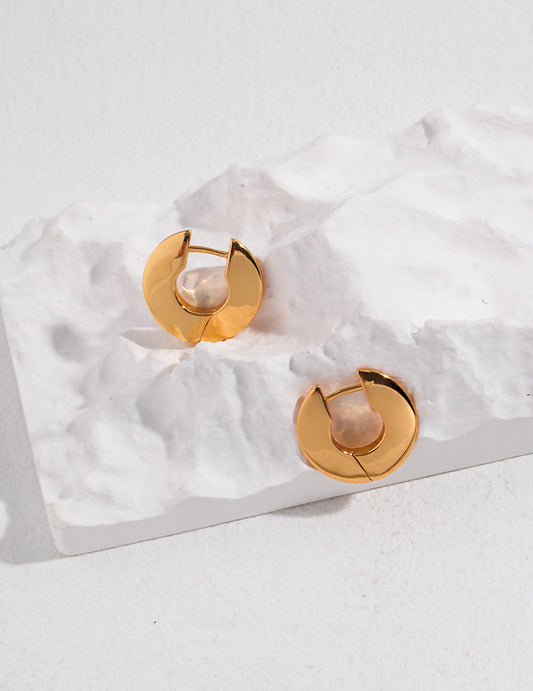 Gold classic design hoops on white marble slab