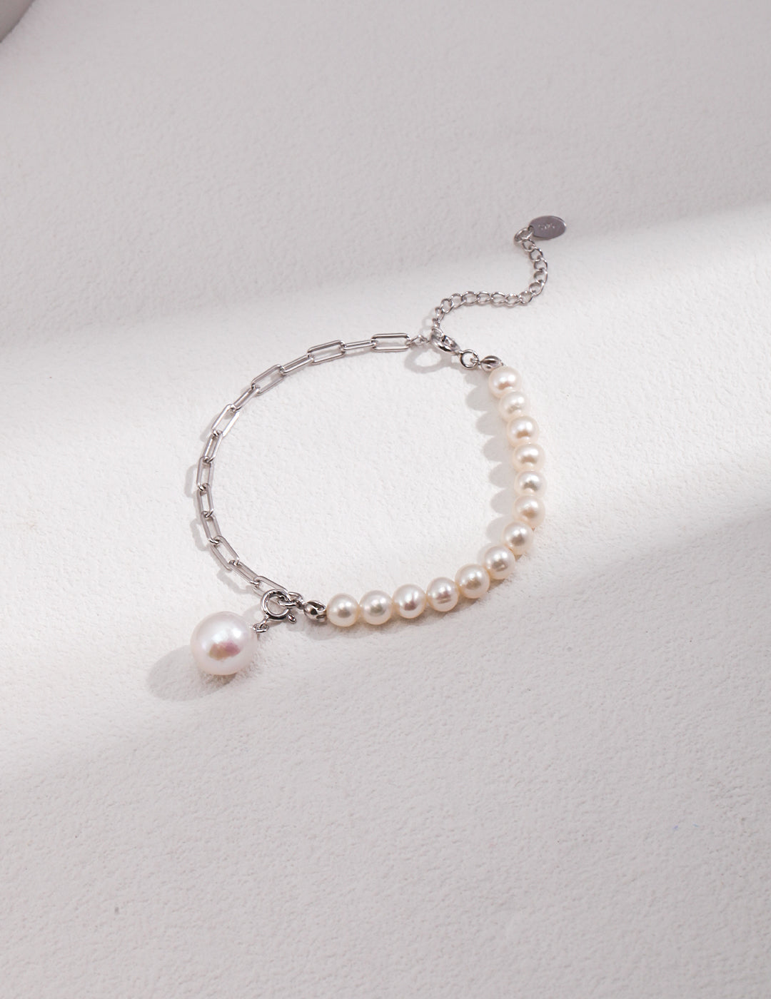 Stylish bracelet featuring silver chain and pearl accents