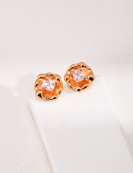 Elegant gold tone earrings adorned with cubic zirconia, featuring a blooming flower design for a touch of sophistication.