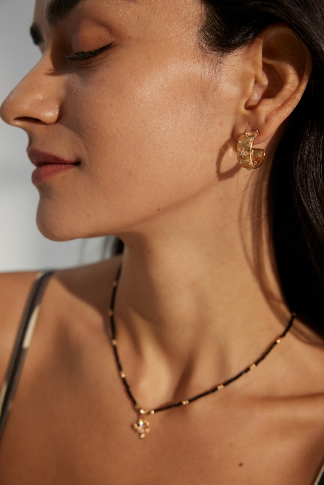Side profile of a woman wearing the Florence Hoops, showcasing the executive scale and presence of the jewelry.
