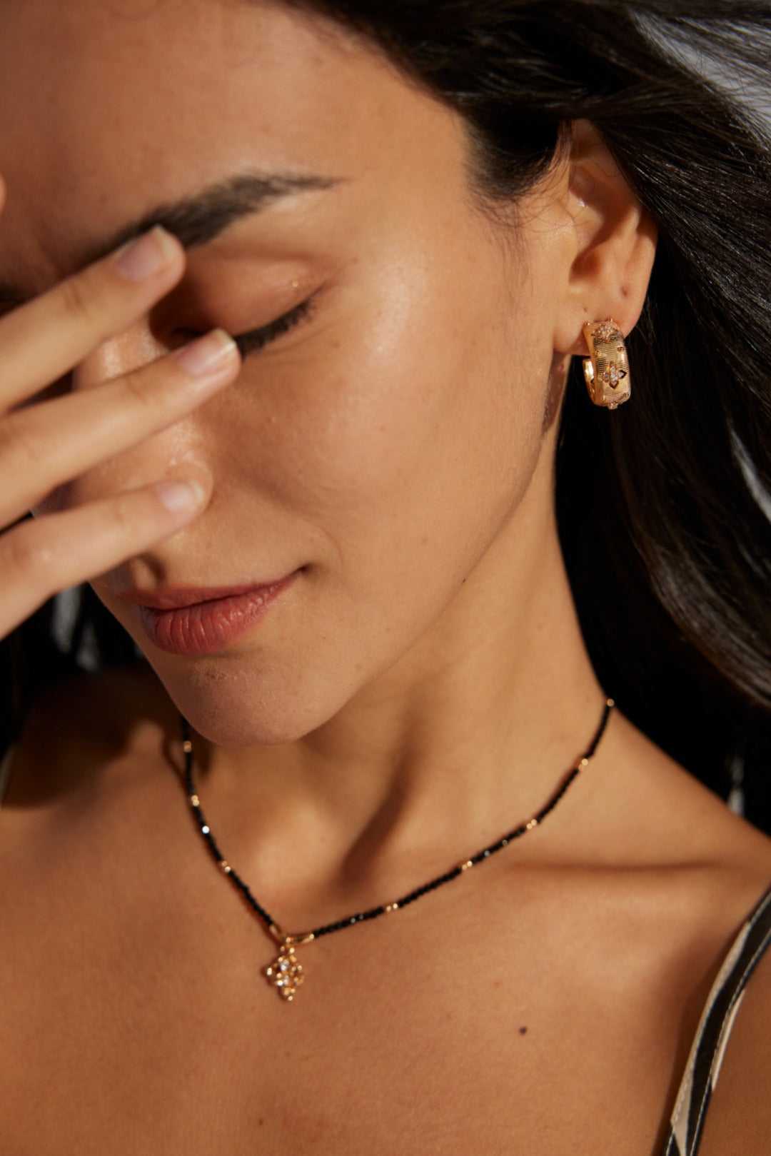 Close-up view of the Florence Hoops in 18k gold vermeil, emphasizing the intricate floral zirconia details and textured finish.