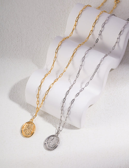 Two gold and silver necklaces, featuring silver and gold plated coin pendants.