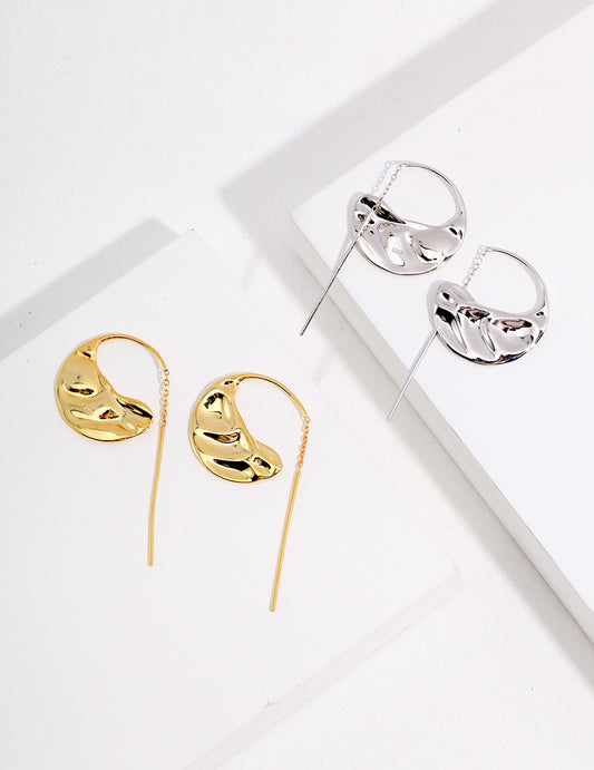 Two pairs of elegant earrings, one in gold and the other in silver, beautifully crafted.