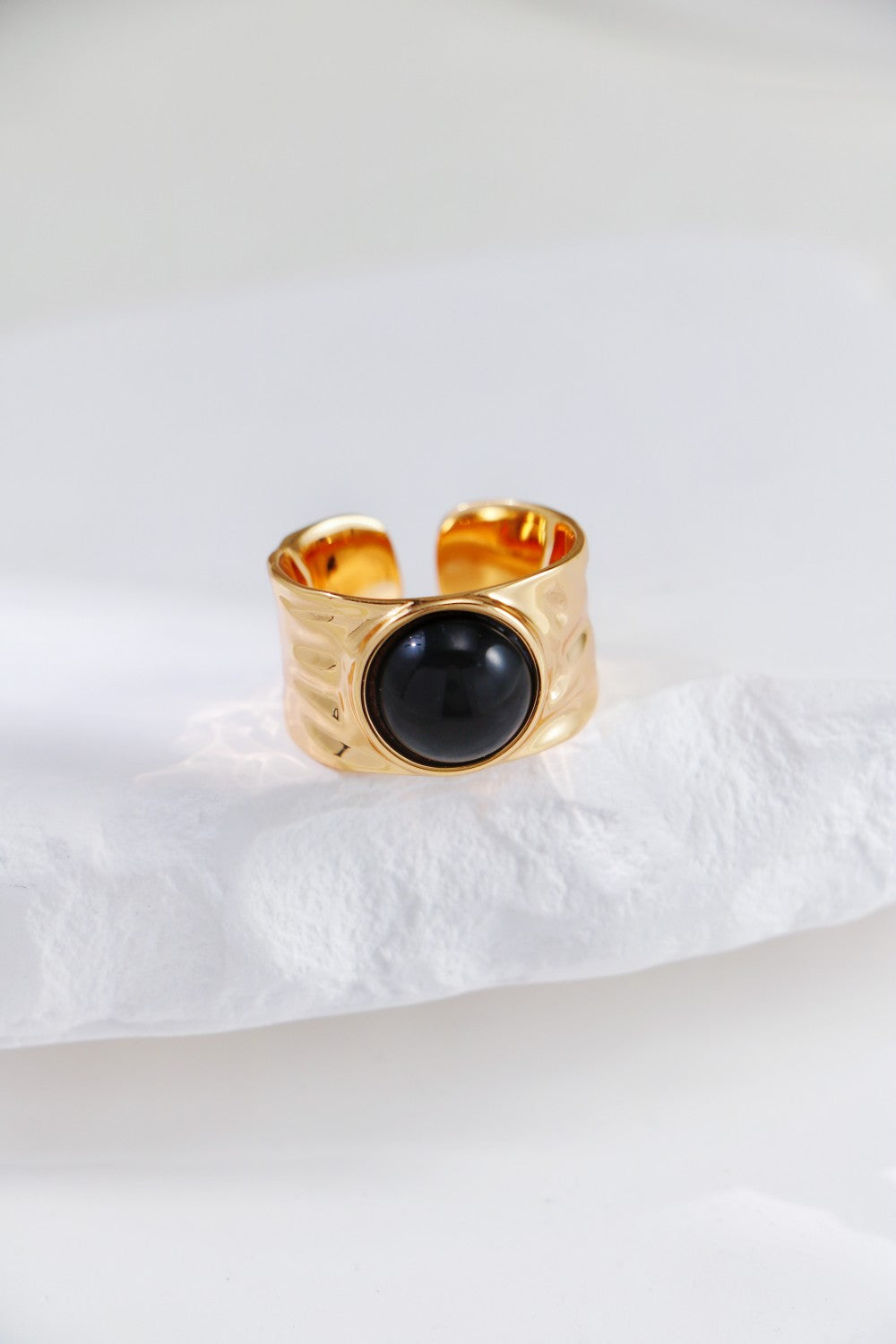 Beautiful gold ring with a polished black agate stone, perfect for adding a touch of elegance to any outfit.