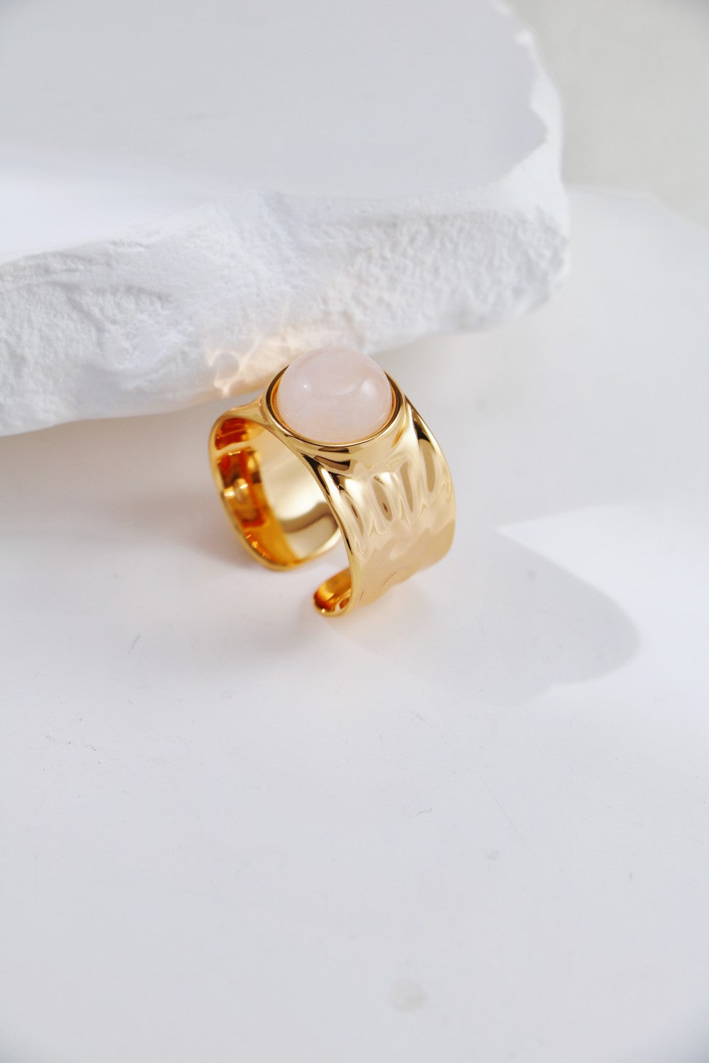 Stunning gold ring with clear quartz, complemented by a bold gold band, embodying beauty and refinement.