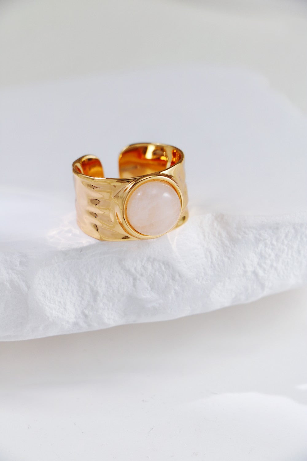 A stunning gold ring adorned with a clear quartz stone, highlighting its beauty and refined design.