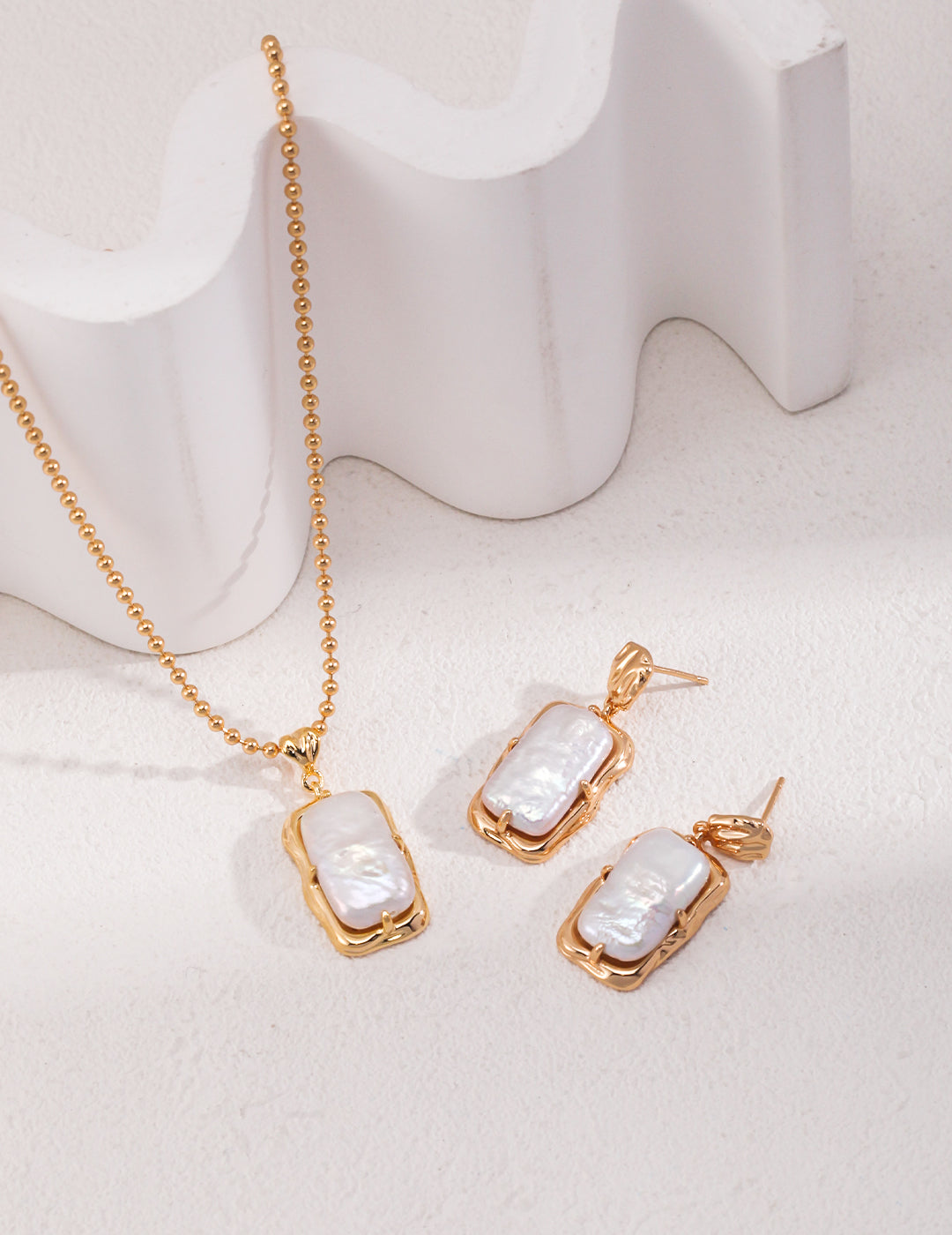 Gold plated freshwater pearl drop earrings and matching necklace set, elegant and timeless jewelry.