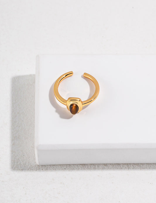 Gold ring featuring an oval-shaped tiger's eye gem.