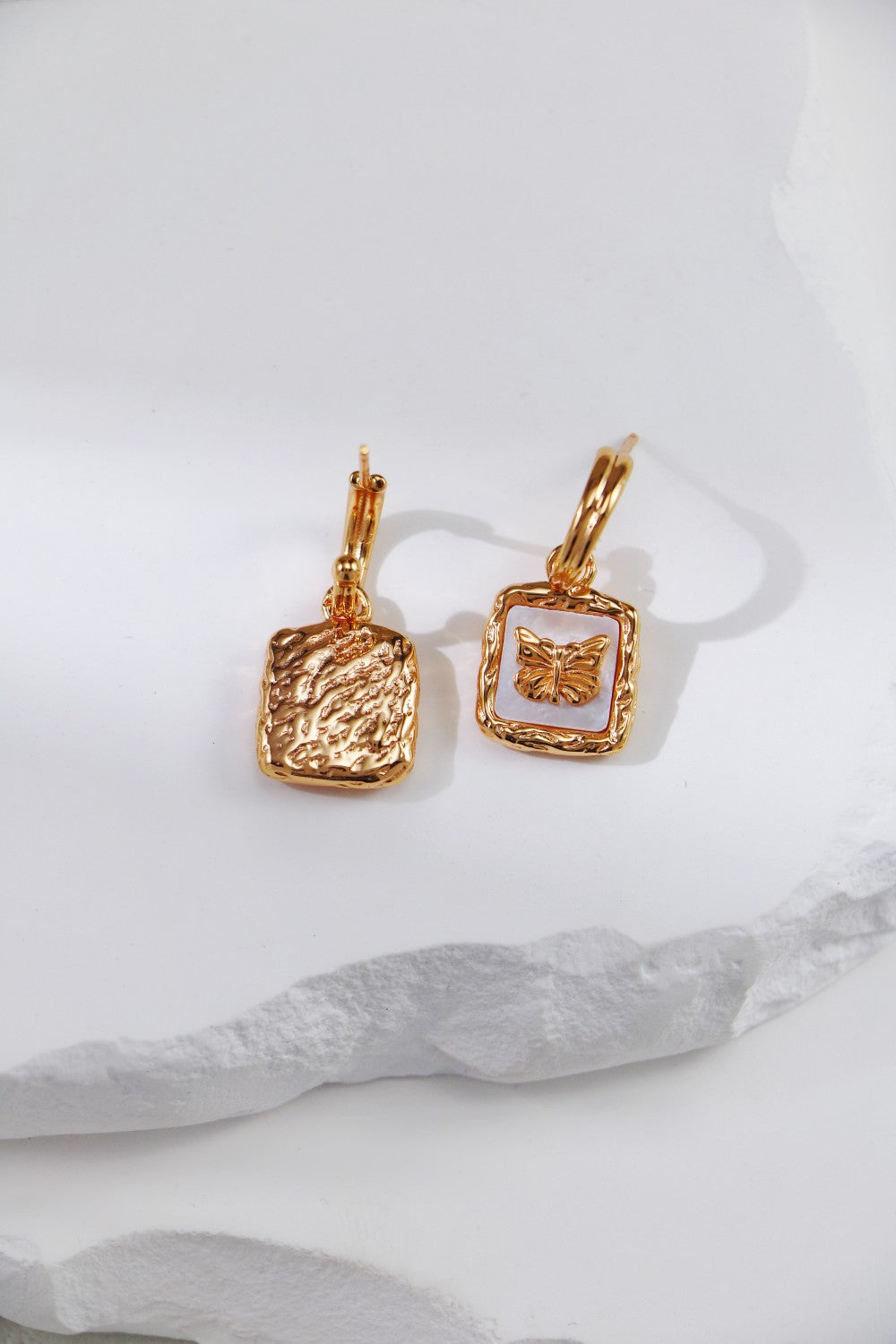 Beautiful gold butterfly earrings, designed with nacre on the front and back, adding a touch of elegance.