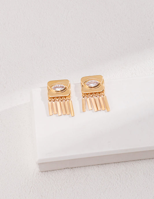 Gold tone earrings with fringe detail and cubic zirconia accents.