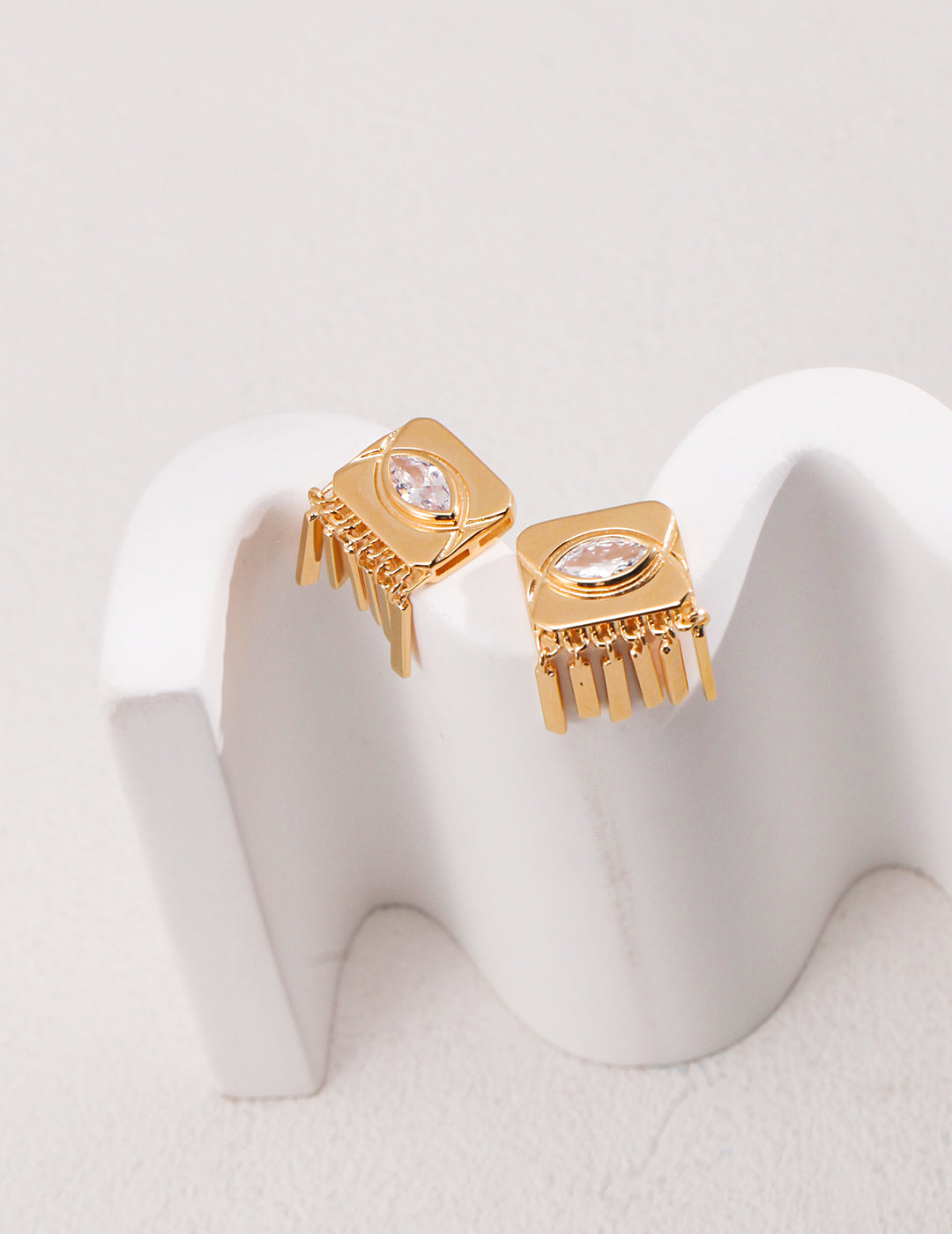 Gold earrings with fringes , adorned with cubic zirconia for added sparkle.