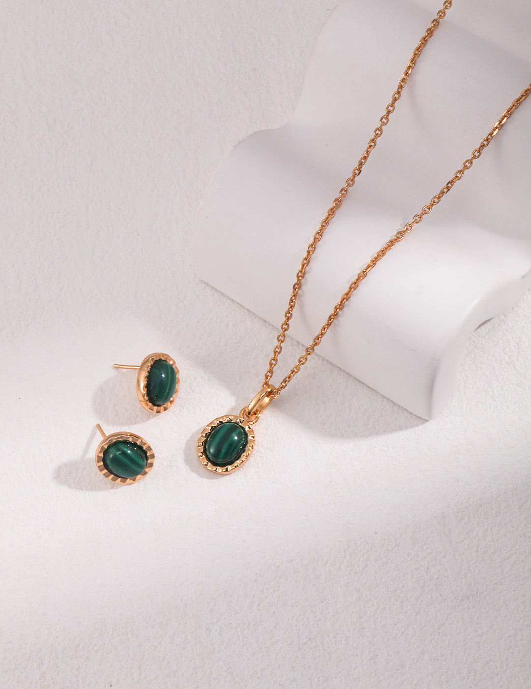 Elegant jewelry set featuring gold malachite necklace and earrings.