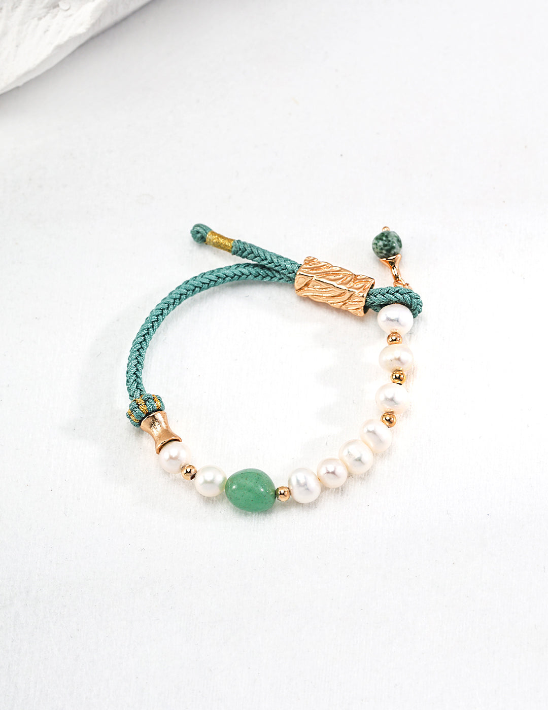 Turquoise bracelet adorned with jasper, pearls, and gold charms