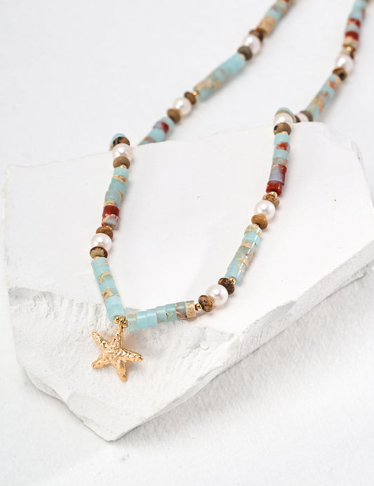 Stylish necklace showcasing a starfish charm and turquoise beads, designed with agalmatolite for added elegance.