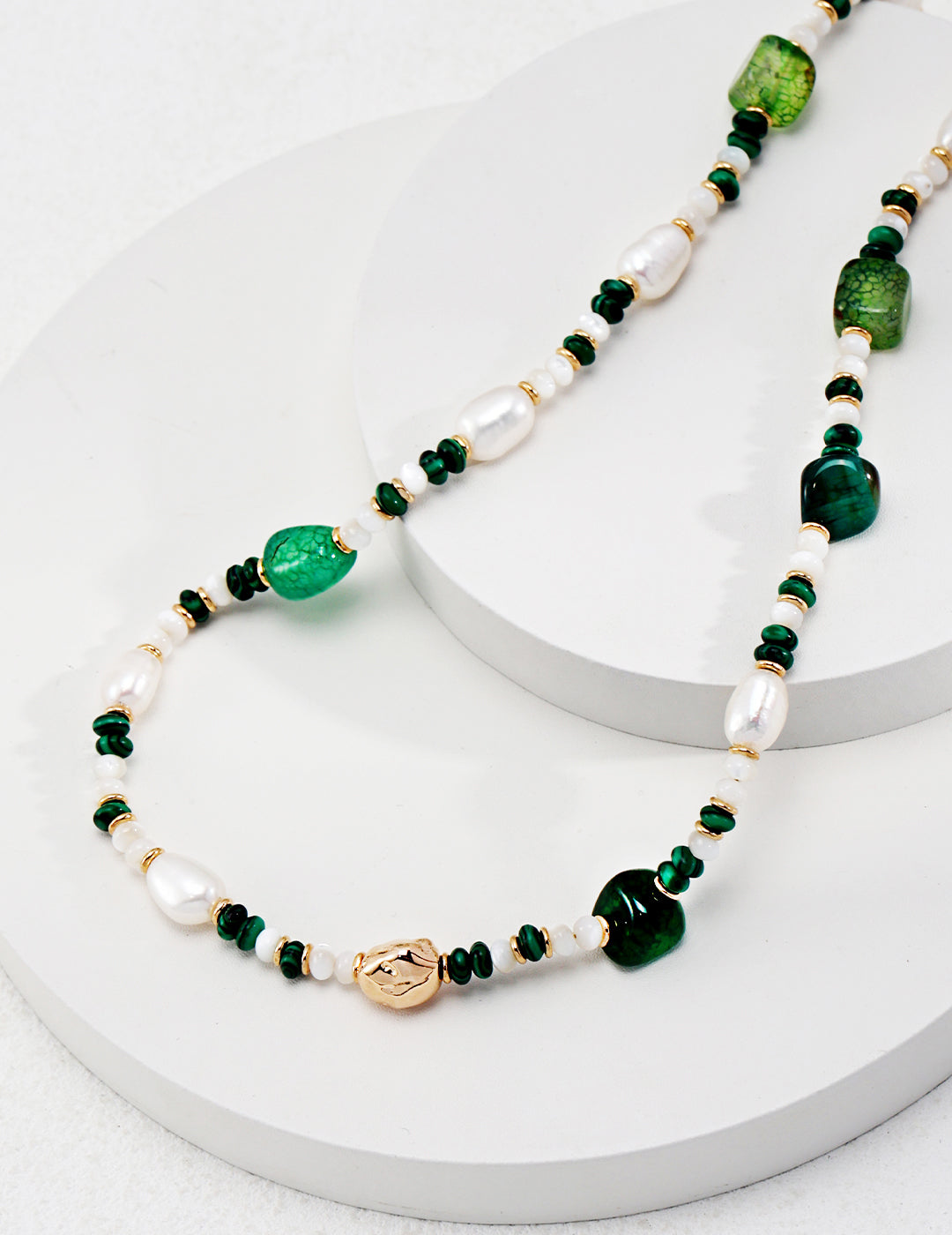 Green and gold malachite and agate necklace with pearls and beads, exuding a lively vibe.