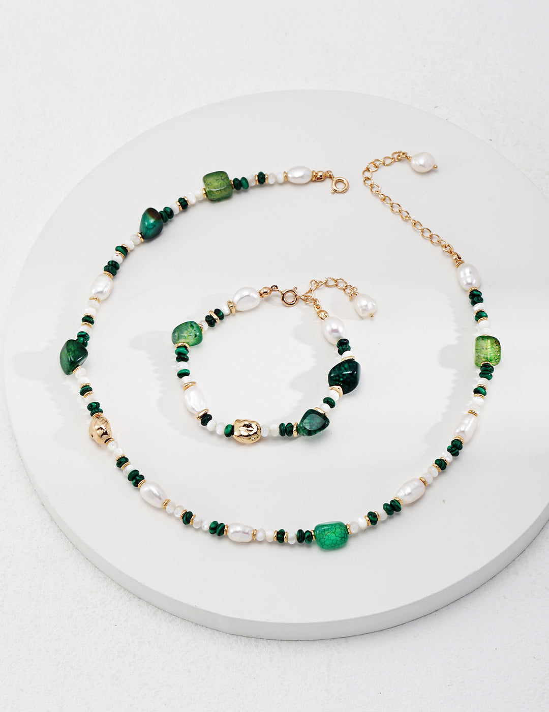 Malachite, agate, and freshwater necklace and bracelet set in green and white hues, radiating energy.