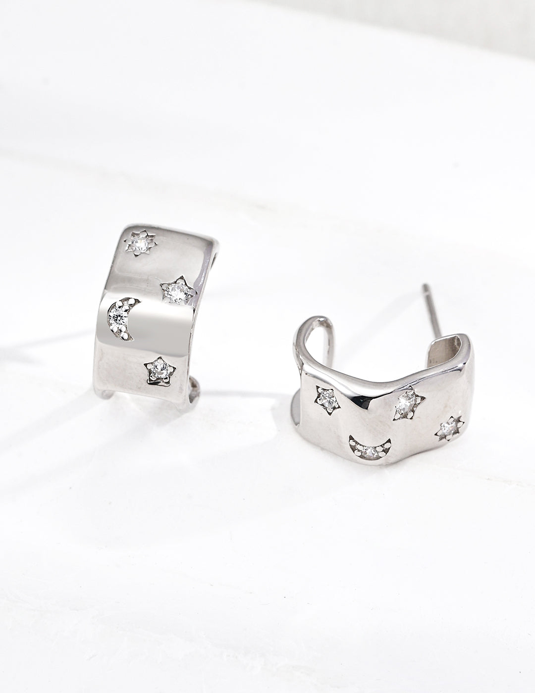 Silver C-Shaped Hoops. from Mezuille, with celestial zirconia accent, displayed on white background