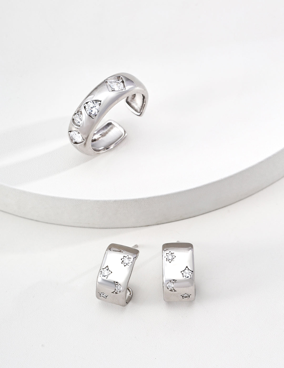 Silver  ring and hoop earrings in zirconia accents from Mezuille on a white background