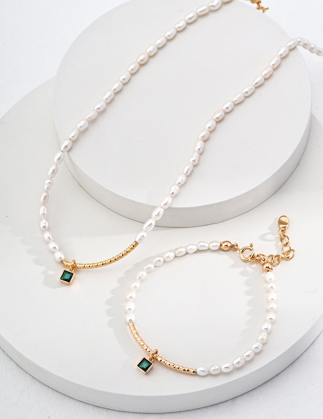 Two luxurious gold-plated necklaces embellished with rich zirconia stones and radiant pearls, highlighting timeless beauty and style.