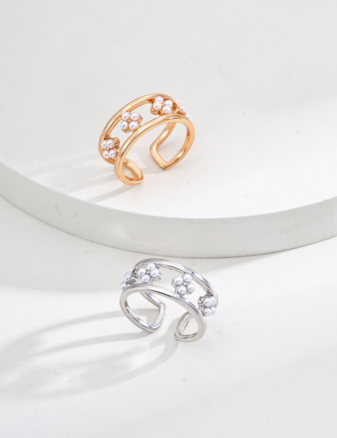 A pair of stylish rings adorned with shell pearls, available in both gold and silver finishes for your choice.