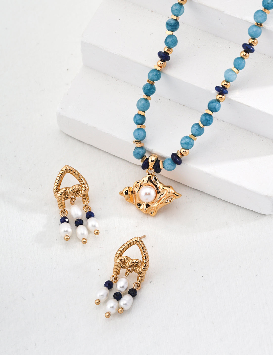 Set of beautiful blue lapis lazuli necklace and knot earrings with pearls.