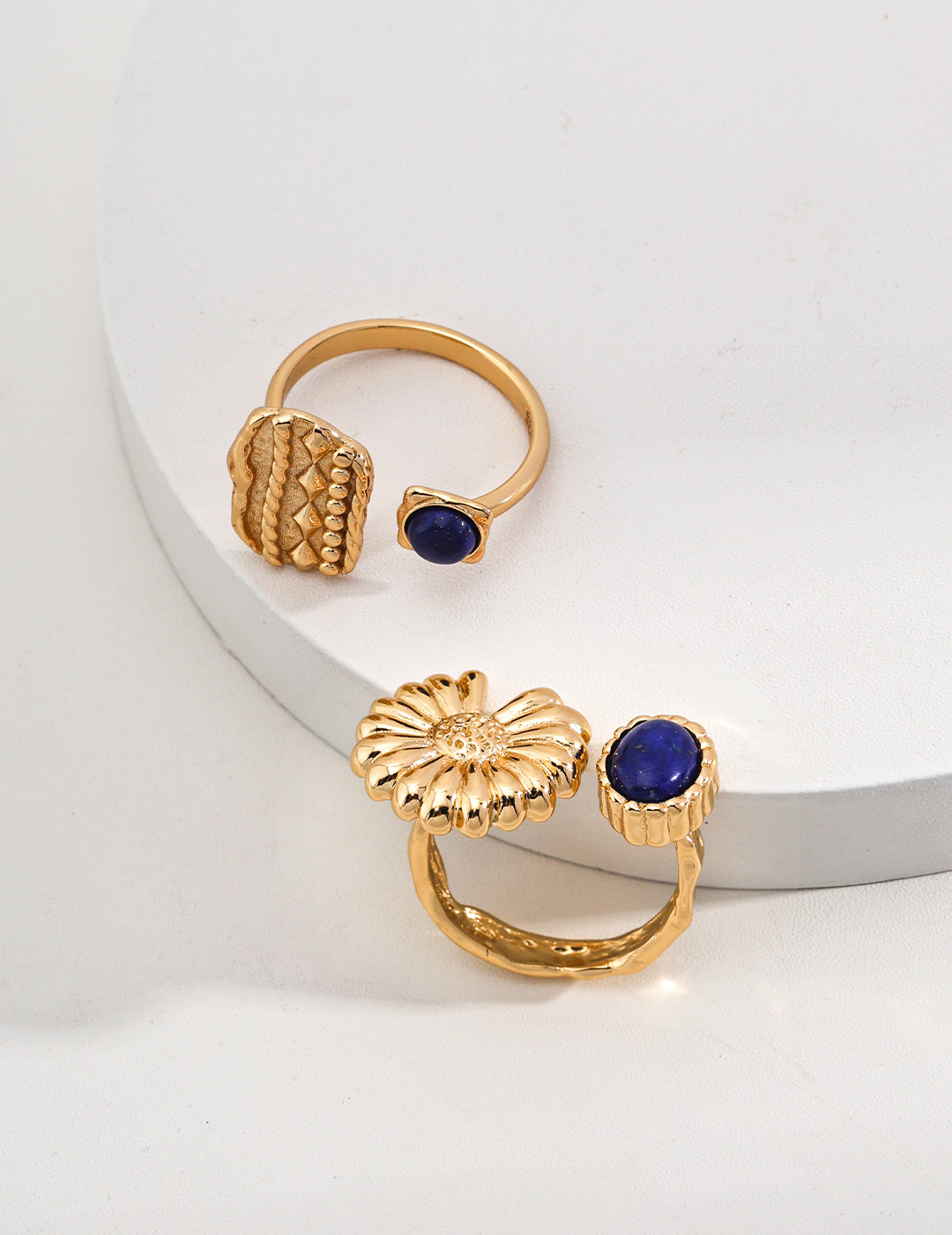 A pair of stylish rings adorned with lapis lazuli, crafted from gold-plated metal for a luxurious touch.