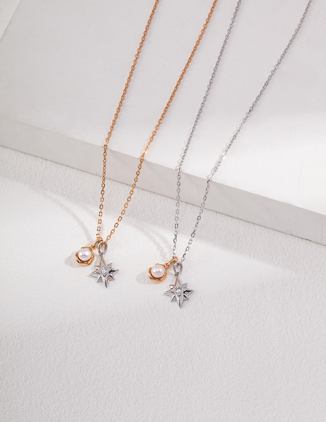 Celestial-themed necklaces with a star and full moon charm, one on a silver chain and the other on a gold chain.