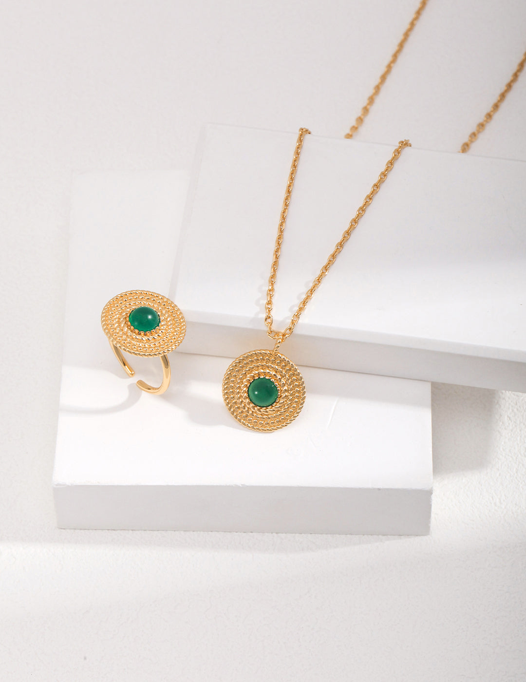 Elegant gold necklace and ring set with chalcedony stones in a beautiful green hue.