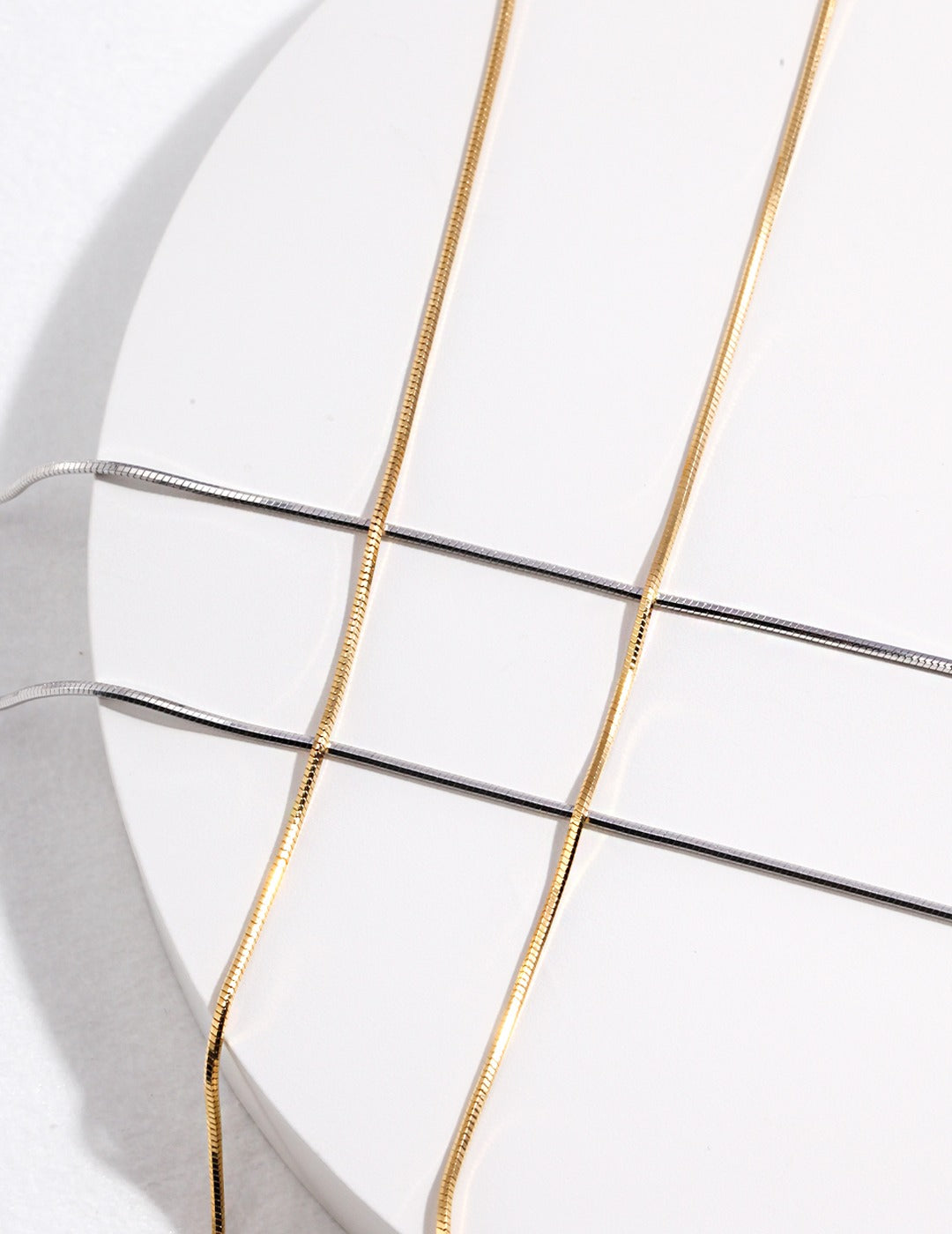 Stylish gold snake chain necklaces featuring white plate.