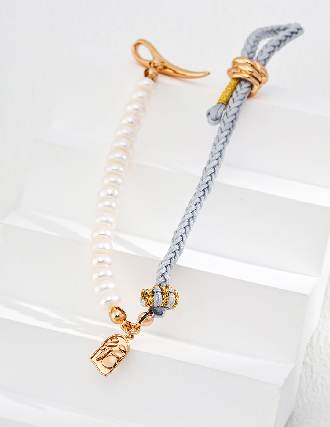 Elegant gold plated bracelet featuring baby blue hemp and beautiful pearls.