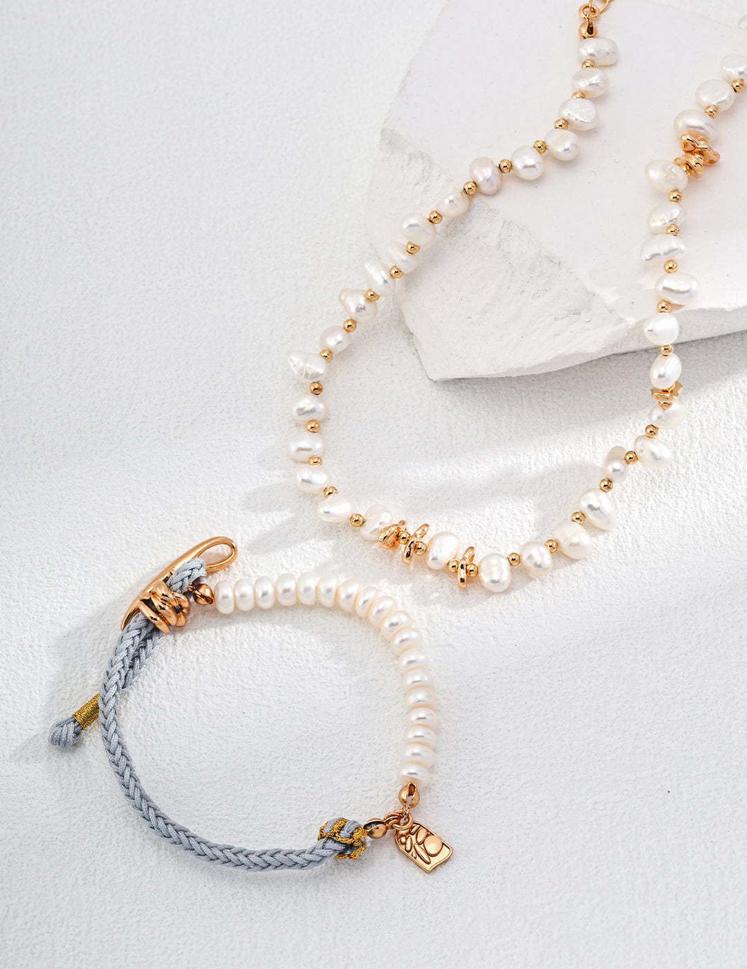 Pearl jewelry set, featuring bracelet and necklace.