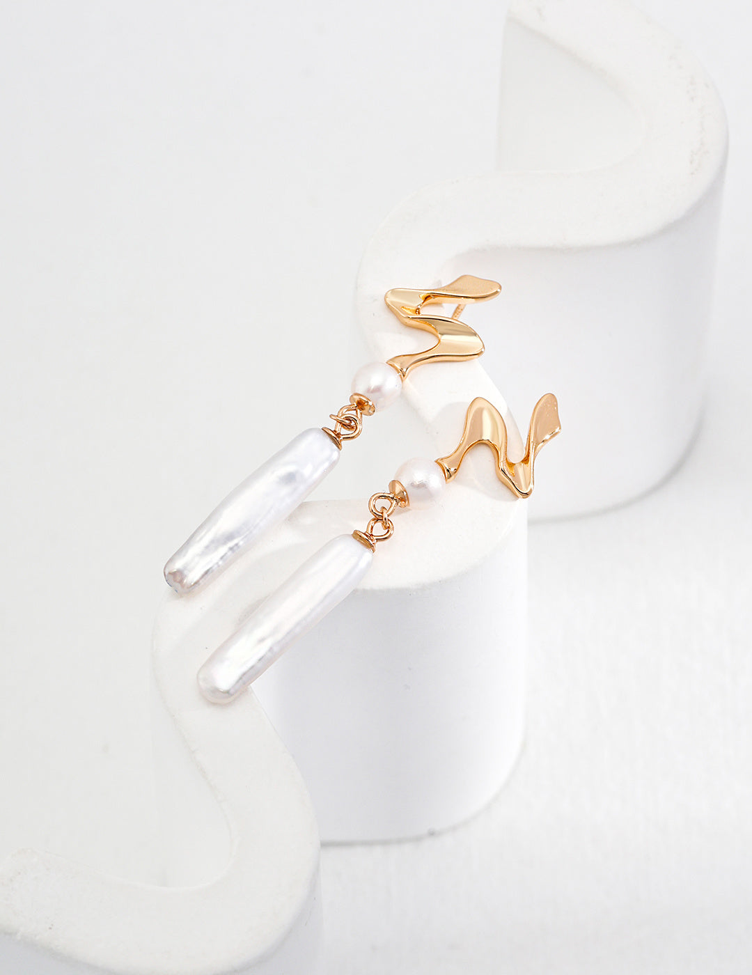 Chic gold and white earrings showcasing a delicate pearl, ideal for enhancing your jewelry collection.