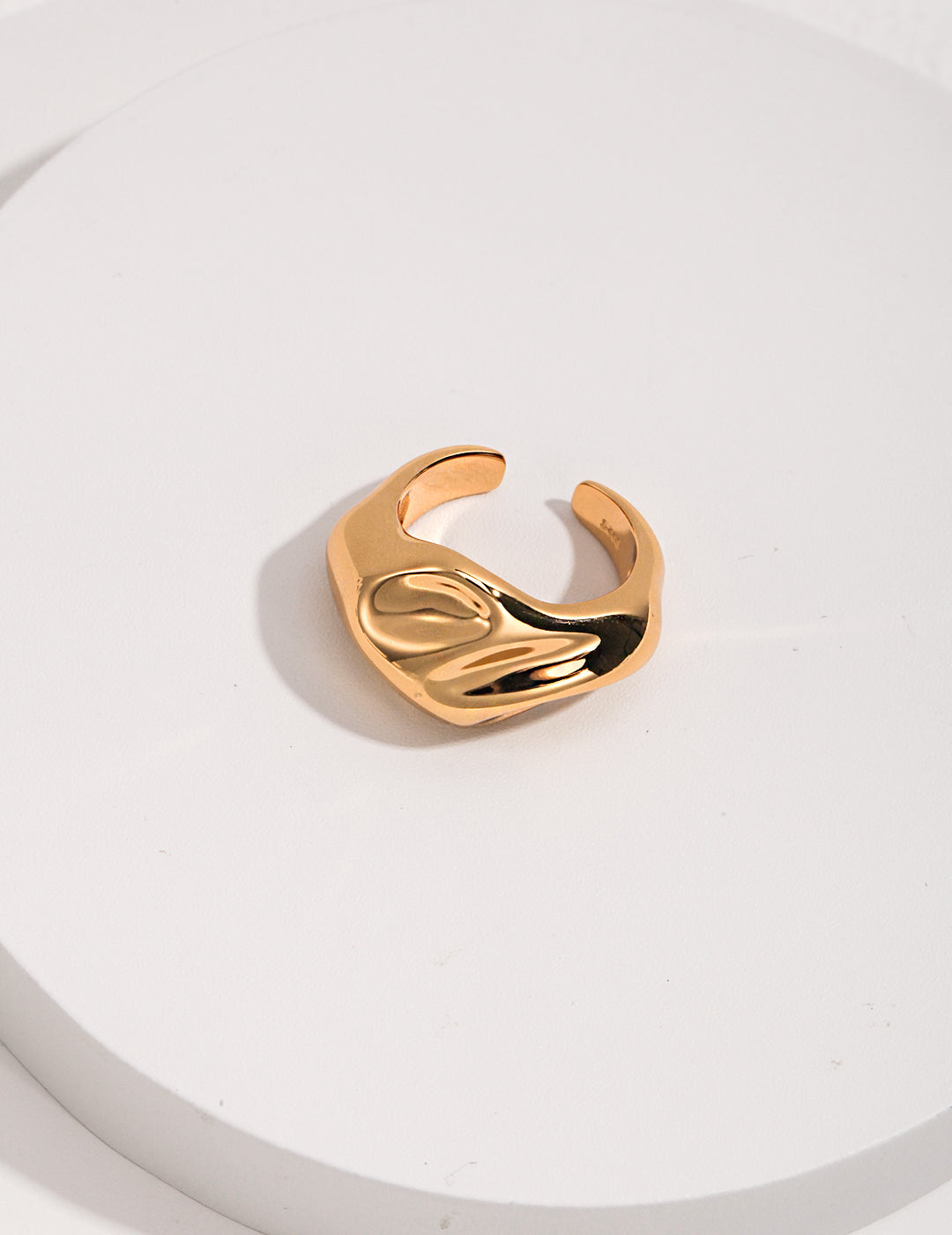 Shiny gold ring on white background.