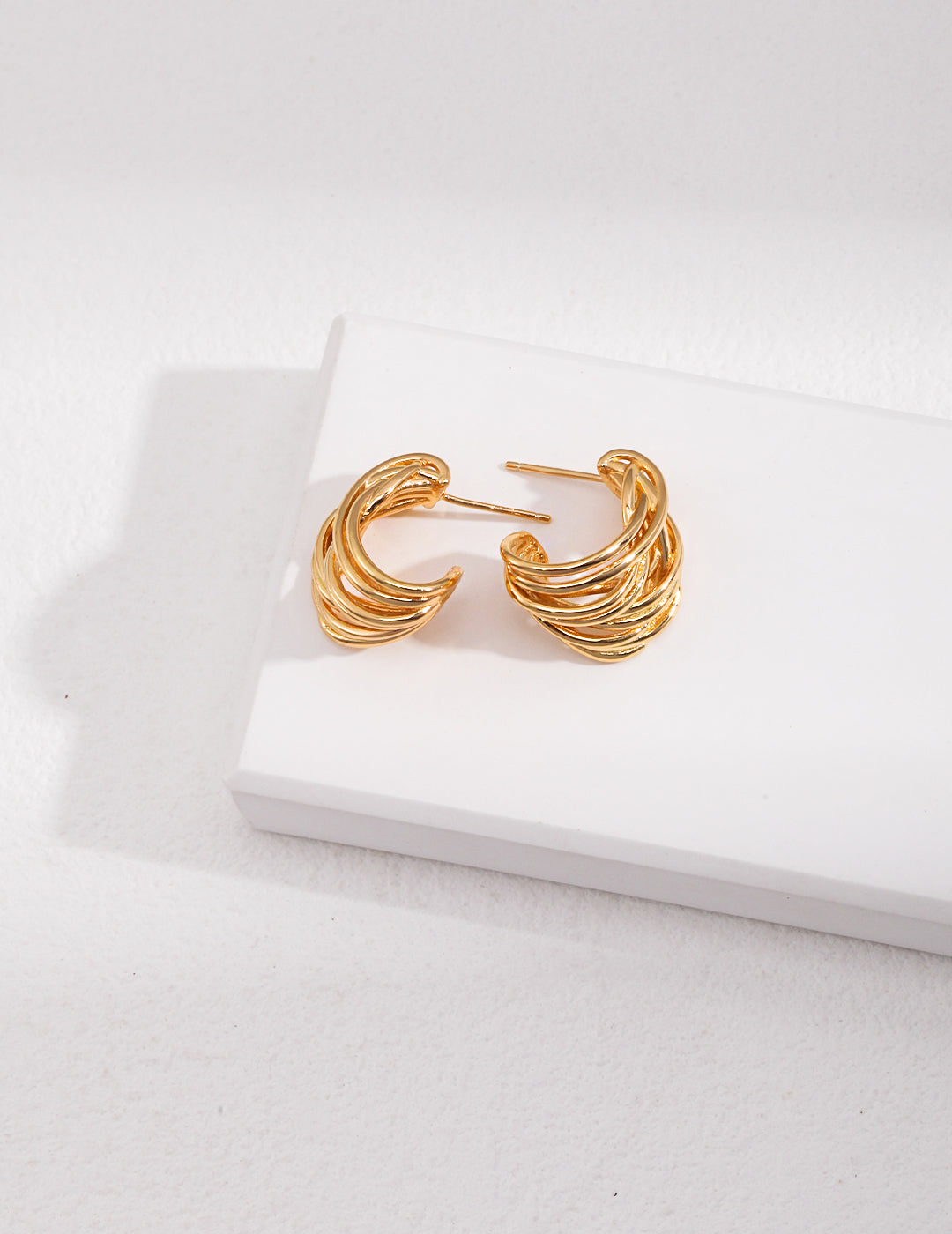 Shiny gold plated hoop earrings, perfect accessory for any outfit.