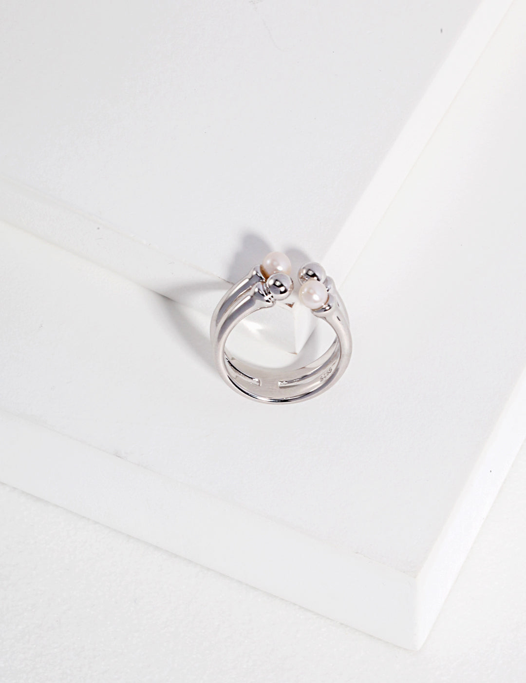 A silver ring with dainty beads and freshwater pearls.