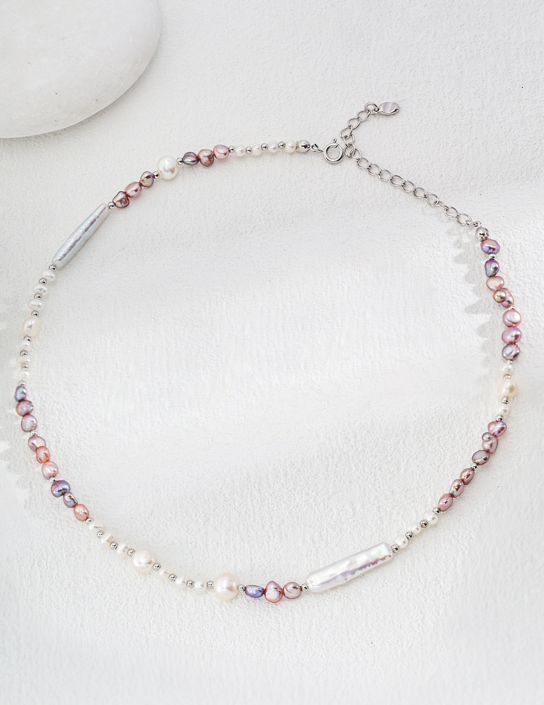 Elegant lavender necklace adorned with a mix of white and pink pearls, showcasing a timeless and sophisticated design.